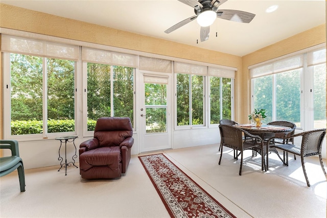 sunroom / solarium featuring plenty of natural light and ceiling fan