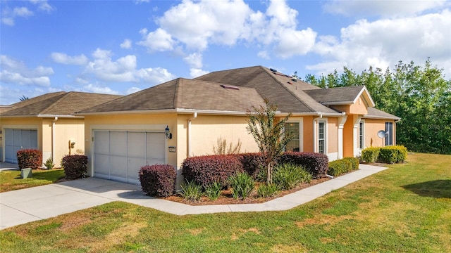 view of front of home featuring a garage and a front yard