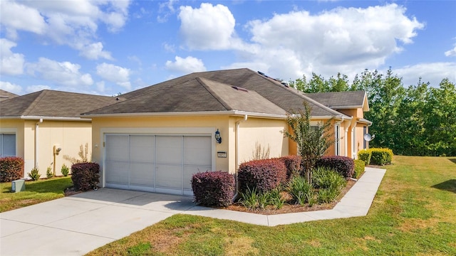 view of side of home featuring a garage and a lawn