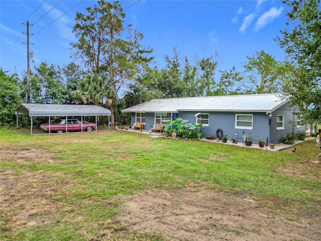 exterior space with a yard and a carport