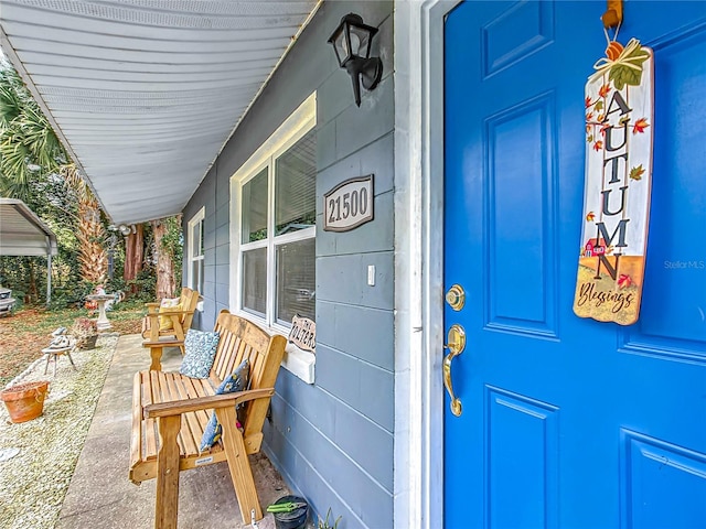 doorway to property featuring covered porch