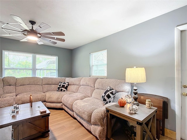 living room featuring ceiling fan and hardwood / wood-style flooring