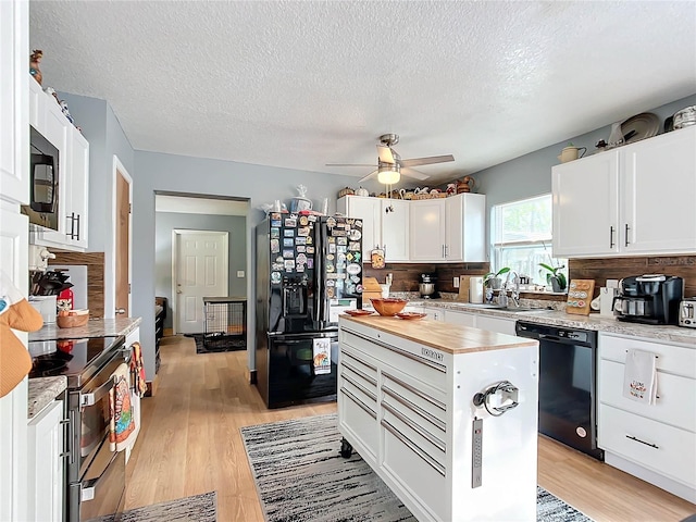 kitchen with black appliances, white cabinets, sink, a textured ceiling, and tasteful backsplash