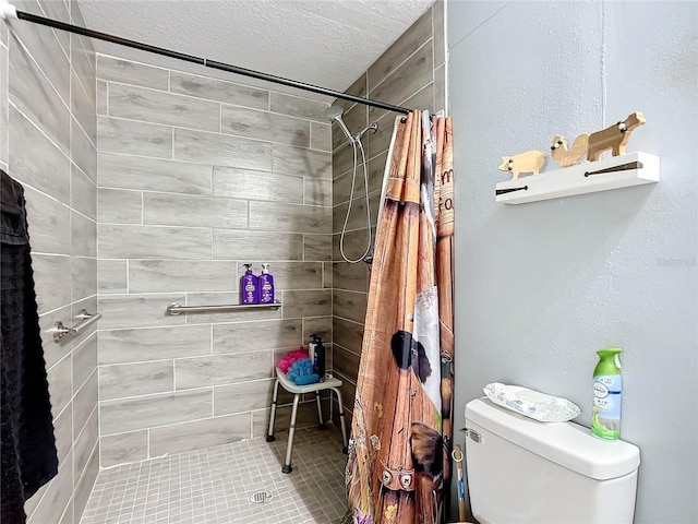 bathroom featuring toilet, a textured ceiling, and walk in shower