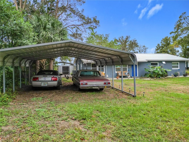 view of car parking with a yard and a carport