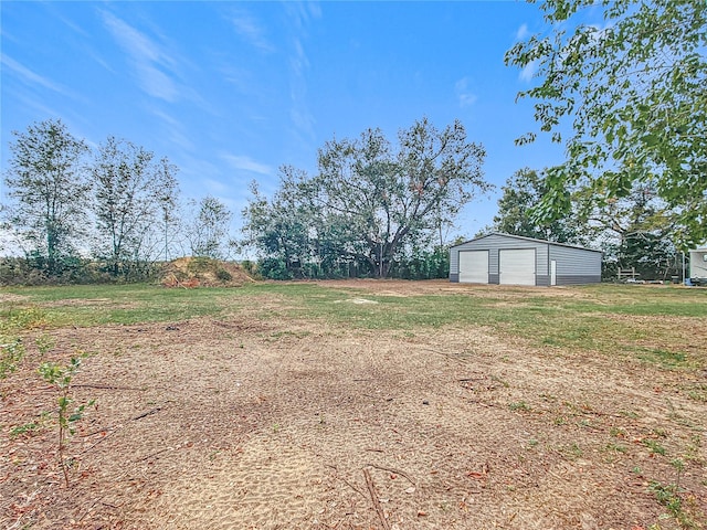 view of yard with an outbuilding and a garage