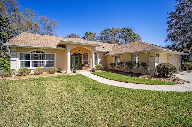 view of front facade featuring stucco siding, a shingled roof, concrete driveway, a front yard, and a garage