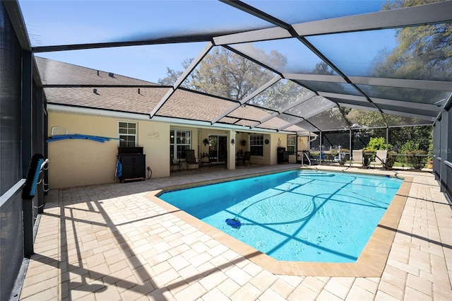 outdoor pool featuring a lanai and a patio