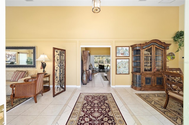 interior space with baseboards and light tile patterned flooring