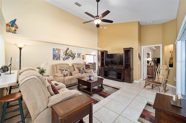 living area featuring a high ceiling, visible vents, and light tile patterned flooring