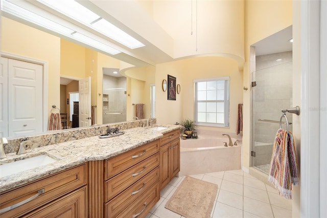 bathroom with a garden tub, a sink, a shower stall, and tile patterned floors