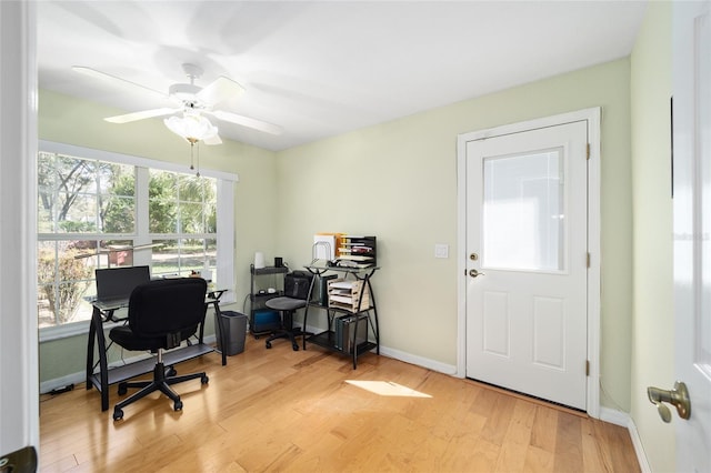 office with light wood finished floors, a ceiling fan, and baseboards