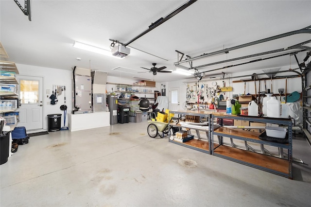 garage featuring a workshop area, heating unit, electric water heater, and a garage door opener