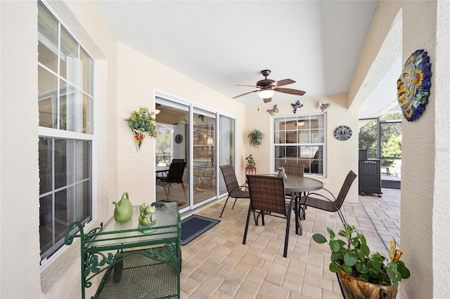 sunroom featuring a ceiling fan