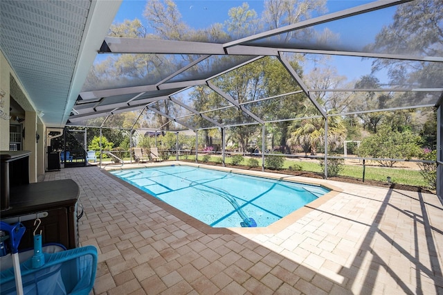 outdoor pool featuring glass enclosure and a patio area