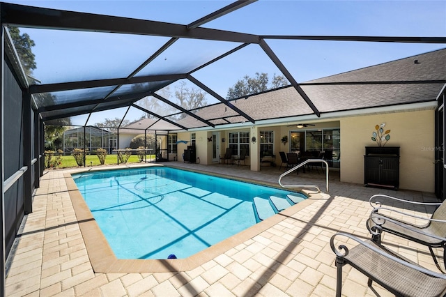 outdoor pool featuring a patio area and glass enclosure