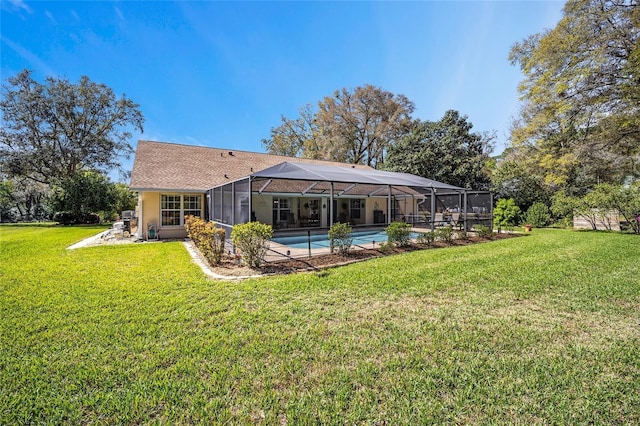 rear view of property with an outdoor pool, glass enclosure, and a lawn