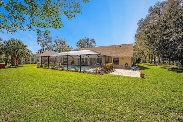 rear view of house featuring a lawn, a patio area, a lanai, and an outdoor pool