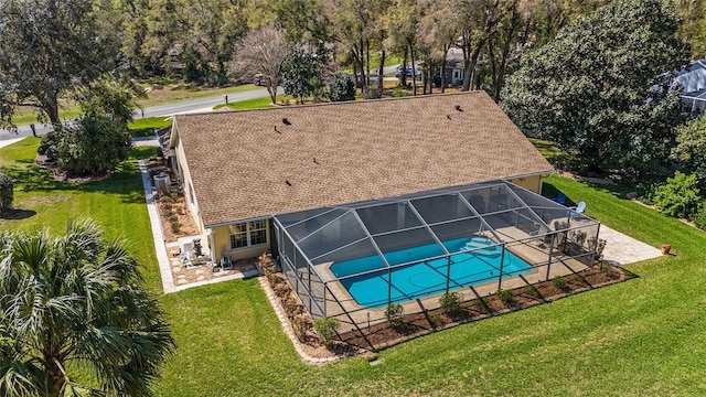 outdoor pool with a lanai, cooling unit, a lawn, and a patio