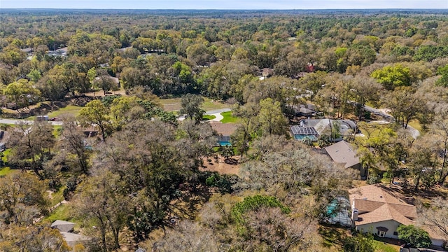 birds eye view of property featuring a view of trees