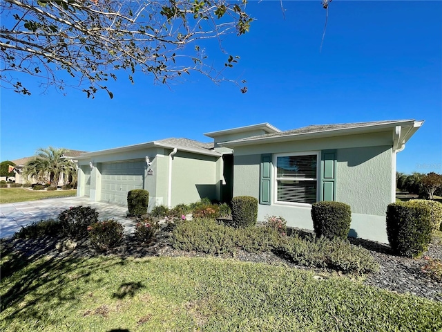 view of front of house featuring a garage and a front lawn