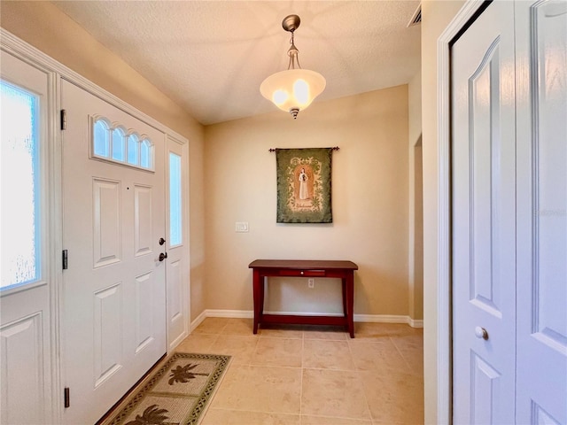 tiled entrance foyer with a textured ceiling