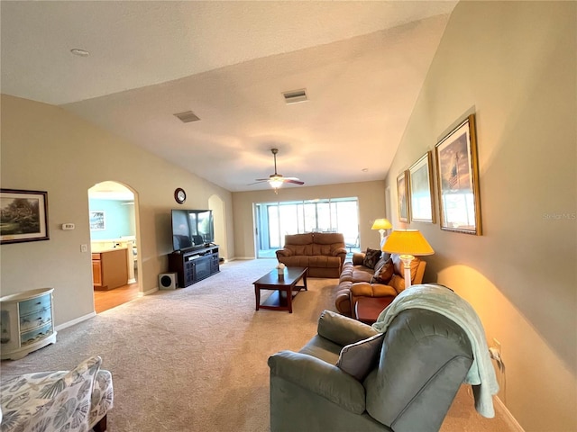 living room with light colored carpet, vaulted ceiling, and ceiling fan