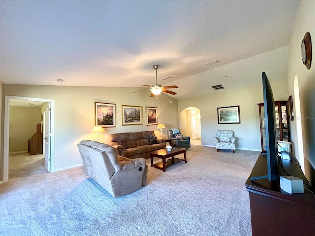 carpeted living room featuring ceiling fan and lofted ceiling