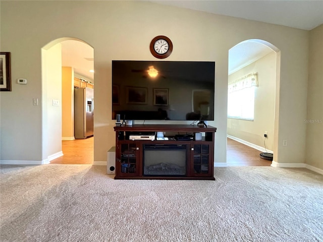 carpeted living room featuring vaulted ceiling