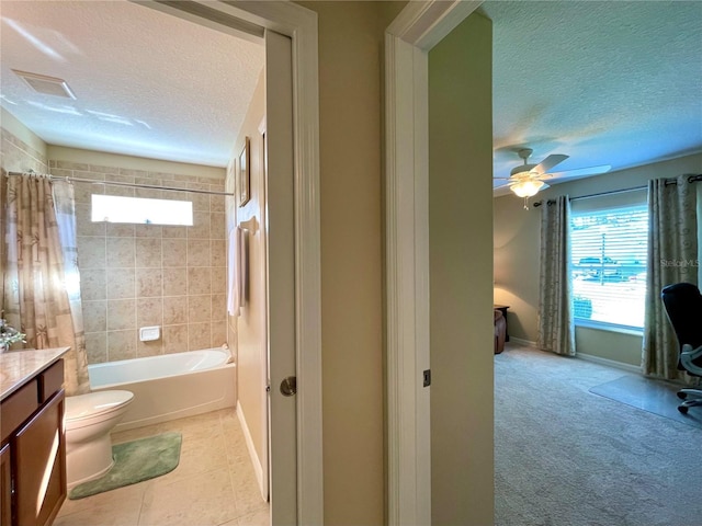 full bathroom with vanity, shower / bath combo, ceiling fan, toilet, and a textured ceiling