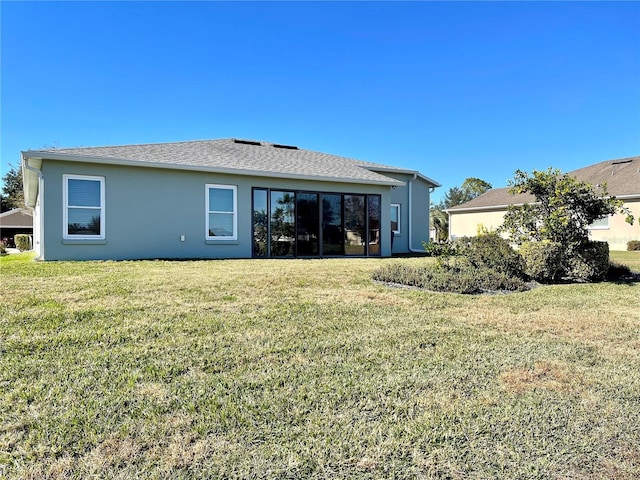 rear view of property with a lawn