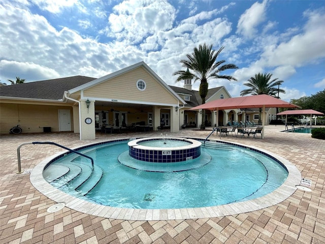 view of pool featuring a patio area and a community hot tub