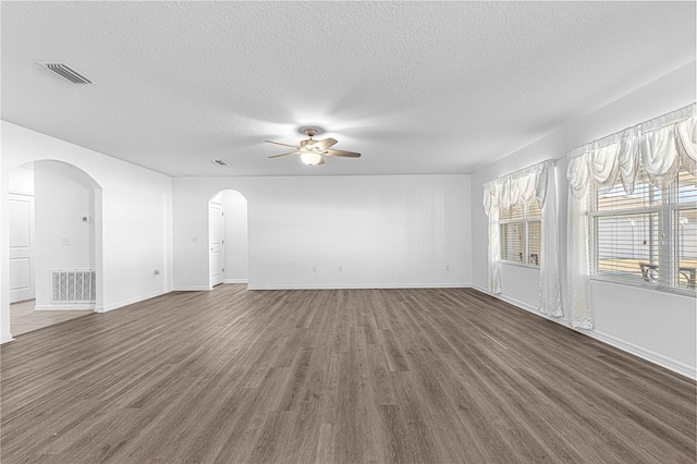 spare room with ceiling fan, dark hardwood / wood-style flooring, and a textured ceiling