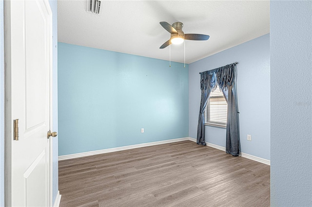 unfurnished room with ceiling fan and light wood-type flooring