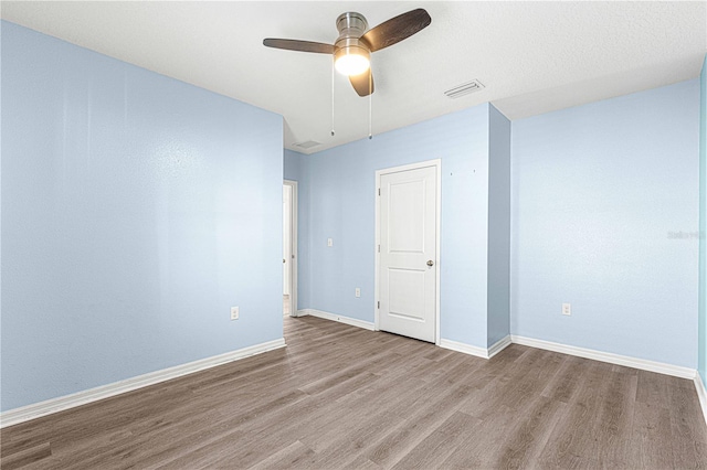 unfurnished room featuring ceiling fan and light hardwood / wood-style floors