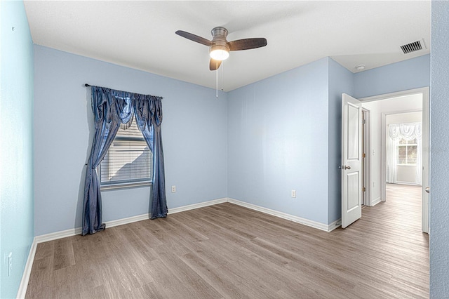 spare room with light hardwood / wood-style floors and ceiling fan