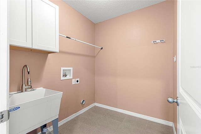 laundry room featuring cabinets, hookup for a washing machine, a textured ceiling, electric dryer hookup, and sink