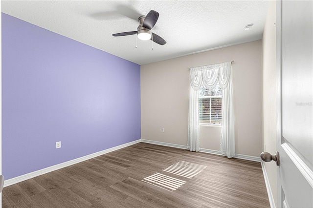 spare room featuring ceiling fan, hardwood / wood-style floors, and a textured ceiling