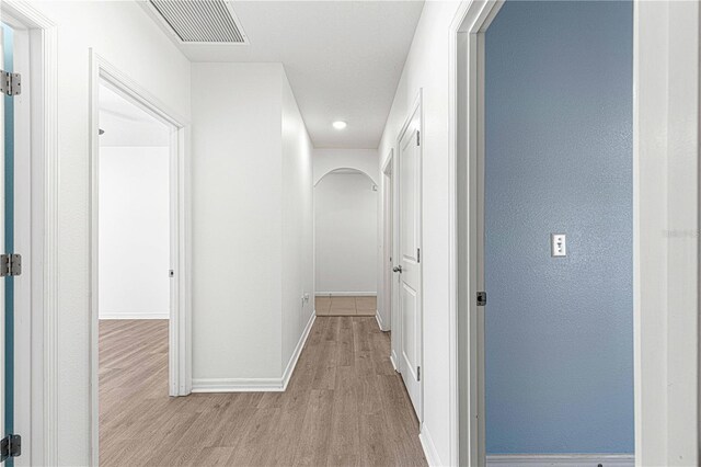 hallway with light wood-type flooring