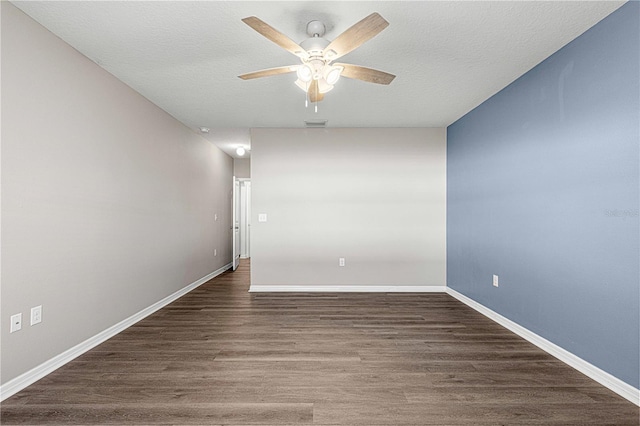 unfurnished room featuring a textured ceiling, dark hardwood / wood-style flooring, and ceiling fan