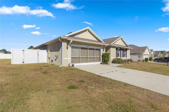 view of front of house with a front yard and a garage