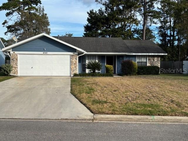 ranch-style house with a garage and a front lawn