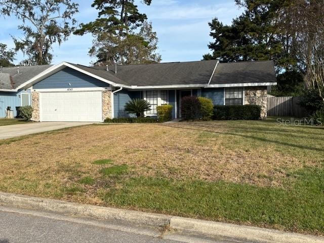 single story home with a front yard and a garage