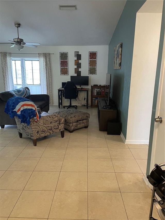 tiled living room with ceiling fan and vaulted ceiling