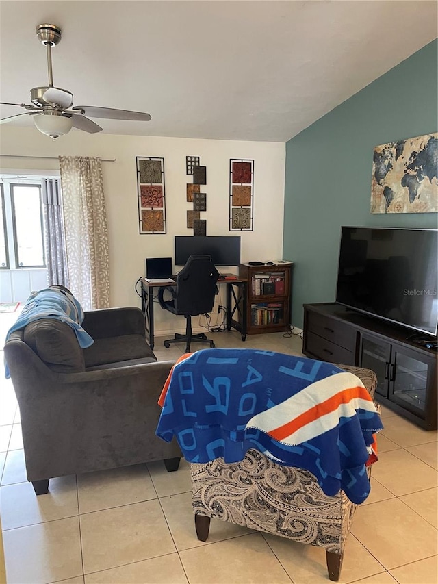 tiled living room featuring ceiling fan and vaulted ceiling