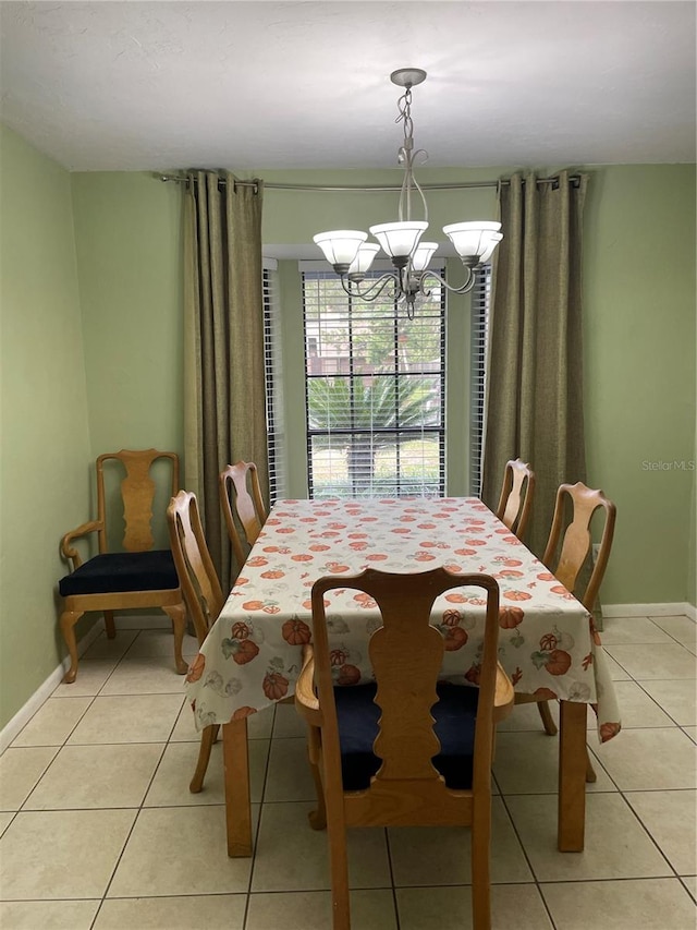 tiled dining area with a chandelier