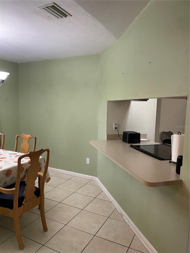 dining area with light tile patterned floors