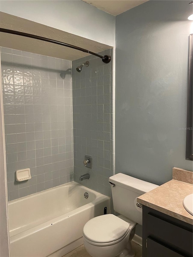 full bathroom featuring vanity, toilet, and tiled shower / bath combo