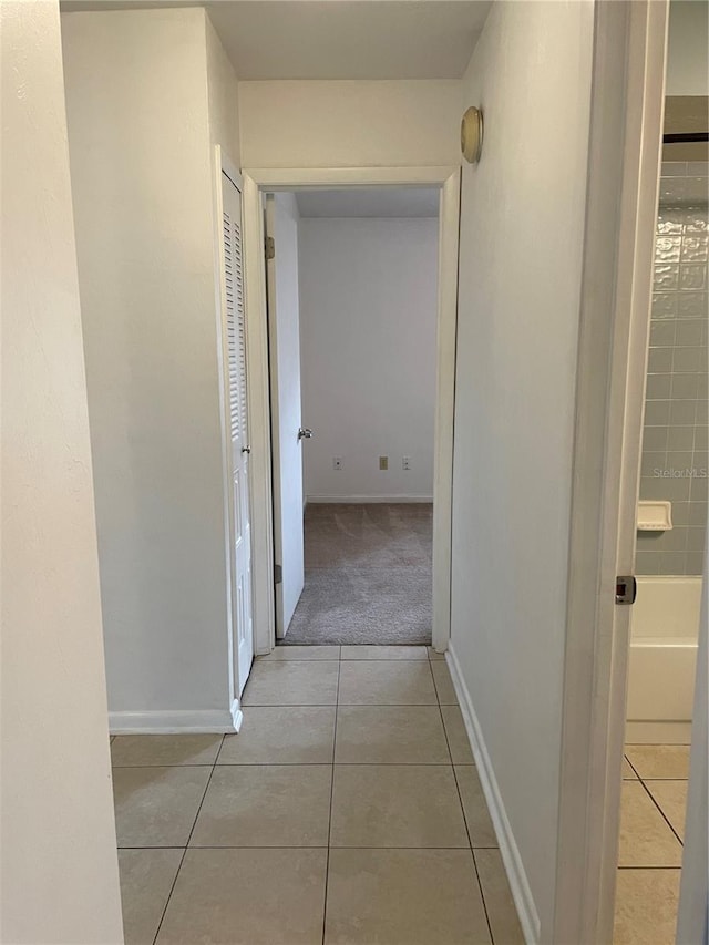 corridor featuring light tile patterned floors