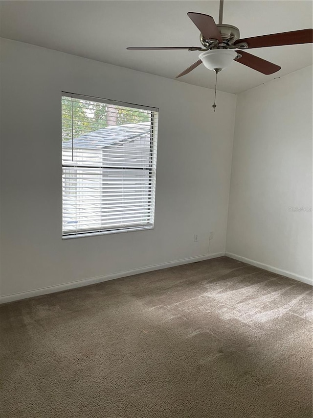 empty room featuring carpet and ceiling fan